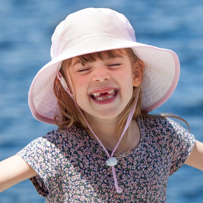 toddler and child wide brim sun hat with chin tie, safety break away clip and toggle-rated excellent sun protection-upf50-made in canada by puffin gear-pink hat-childhood joy-play all day-get outside-day at the lake