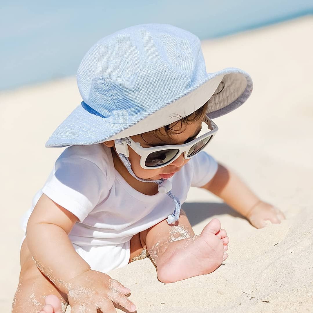 child and toddler wide brim upf50+ excellent sun protection hat with chin tie, cordlock and safety break away clip-machine wash-made in canada by puffin gear-blue hat-day at beach hat