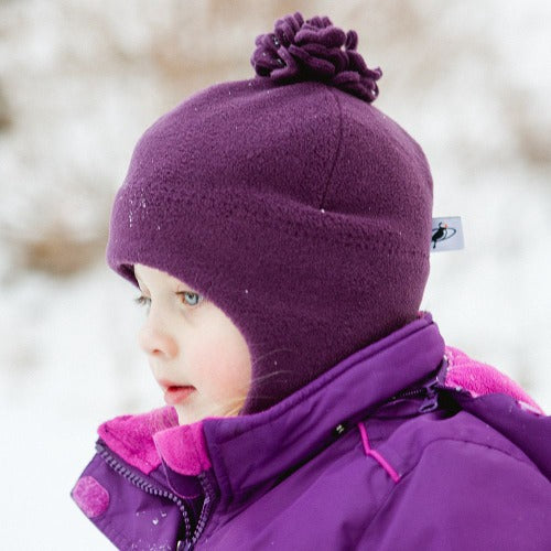 Puffin Gear Kids Polartec Fleece Blossom Hat with Chinwrap and Pompom- fits perfectly around face to keep out all the cold-Made in Canada-shown in plum-warmest kids hats