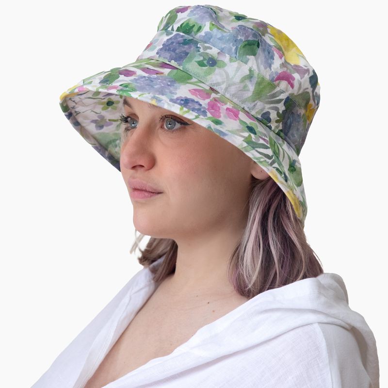 Sun Hat-upf50+ Pastel floral print on woman wearing white linen shirt. made in canada by puffin gear
