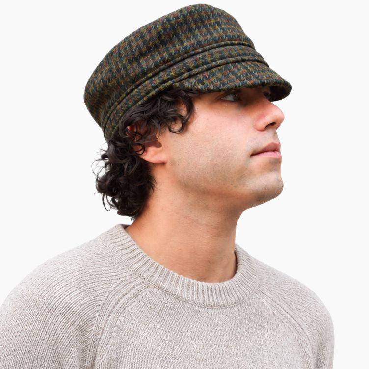 Man in tan wool sweater and harris tweed cap
