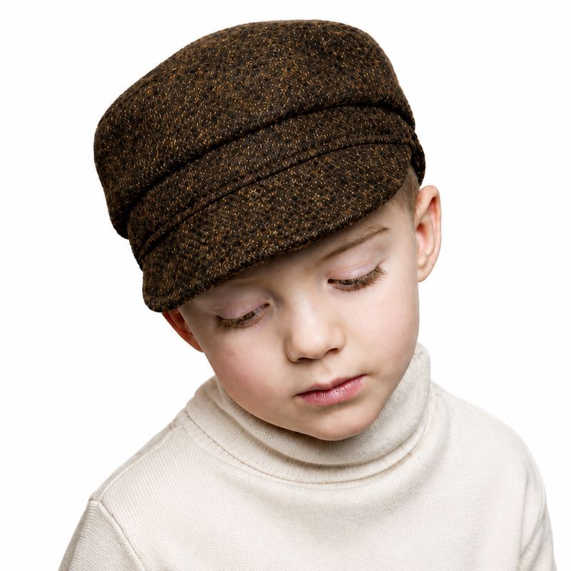 Kid wearing a brown harris tweed newsboy cap in copper tweed colour and a cream ribbed turtleneck sweater. made in canada by puffin gear