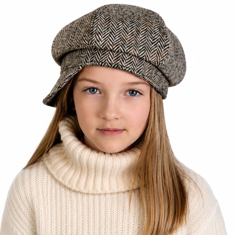 A child wearing harris tweed lichen herringbone wool newsboy cap and a cream ribbed turtleneck sweater. Made in Canada by Puffin Gear
