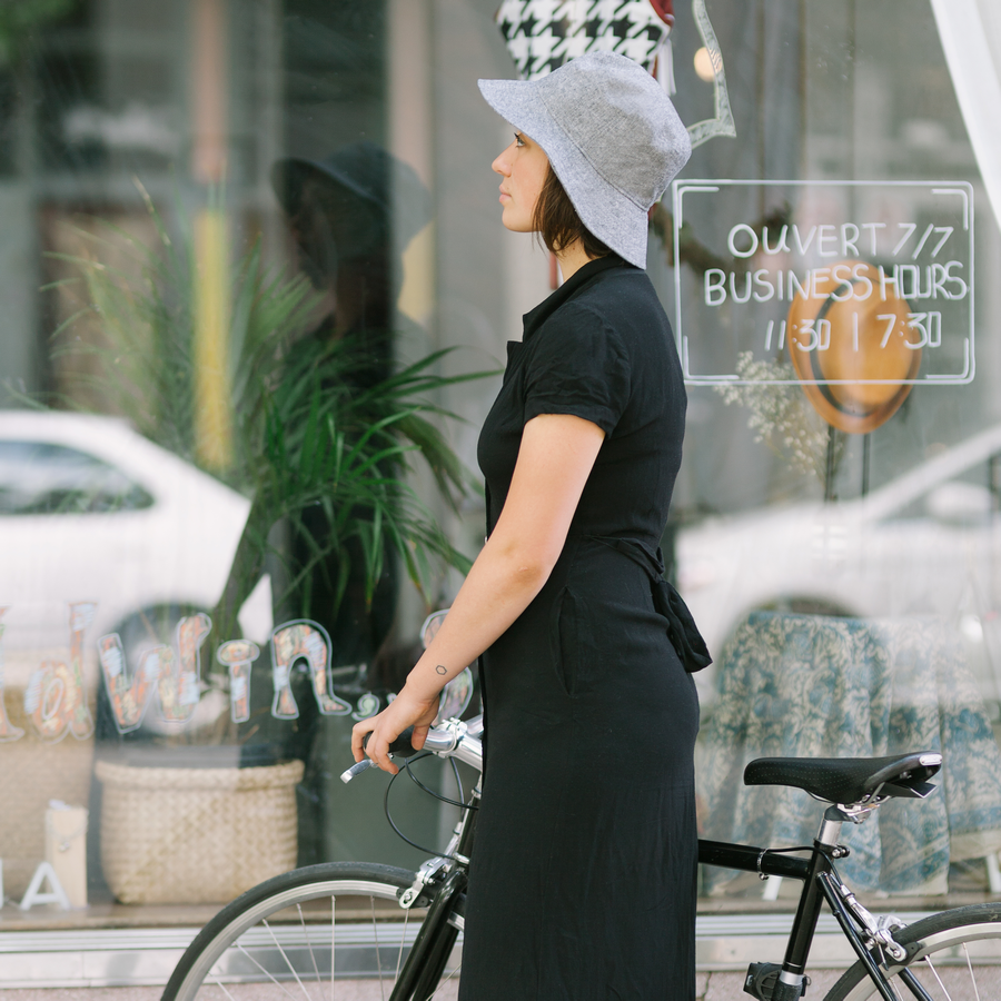 linen crusher sun hat worn by girl window shopping with bicycle-hat made in canada by puffin gear-upf50 sun protection