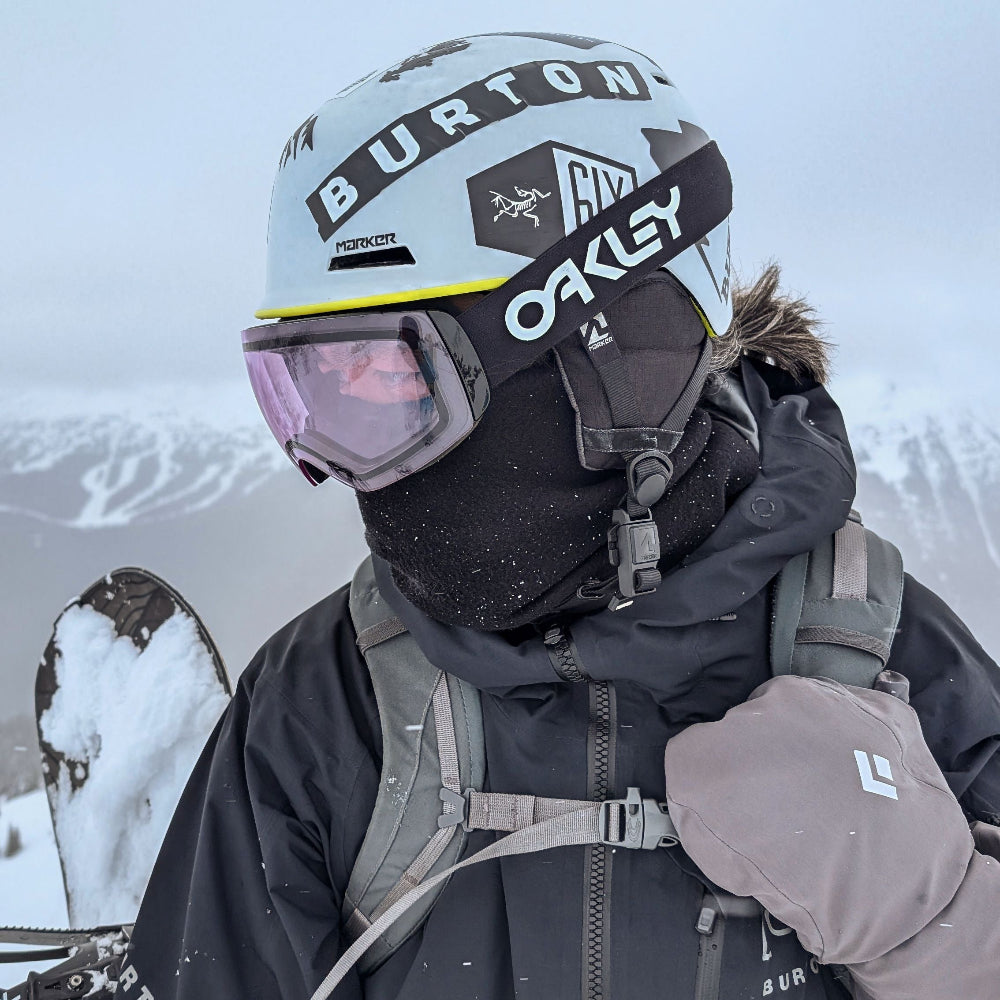back country Snow boarder wearing a black fleece neck warmer, helmet and mitts  - whistler