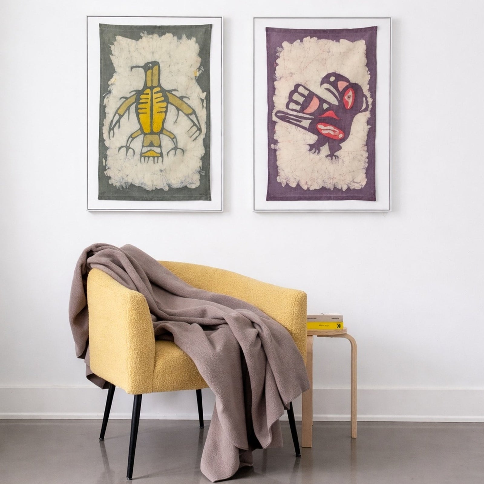 Polartec 300 Fleece Blanket Draped over Gold Chair, Batik Art and side table with books.  Durable, warm blankets made in canada by puffin gear