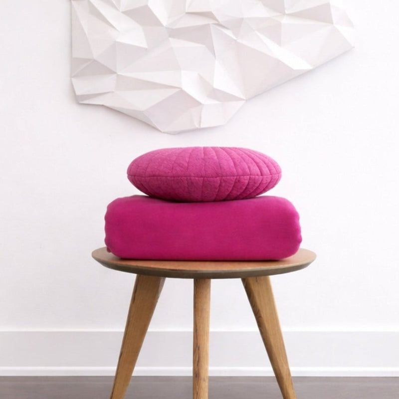 Polartec 300 Fleece Blanket in Azalea-Made in Canada- stacked with pink pillow on side table